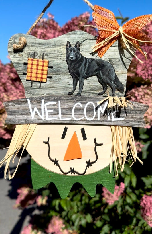 Close-up of the black German Shepherd and scarecrow design on a layered birch wood fall sign.