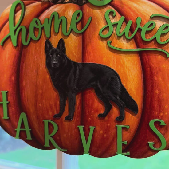 Layered orange pumpkin wood fall sign featuring a black German Shepherd, green lettering, and a hanging cord.